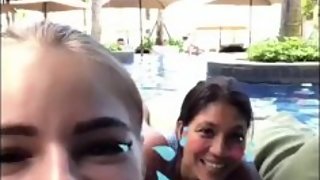 Brunette in swimming pool with friend