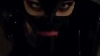 Latex slut doll gives a blowjob to a latex guy