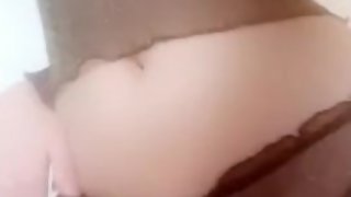 Young sweet girl wearing a see-through top shows off her tits and panties